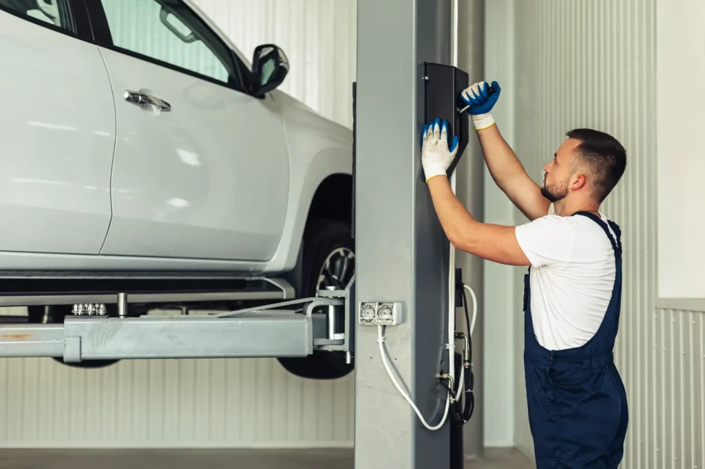 Technician inspecting vehicle during recovery service